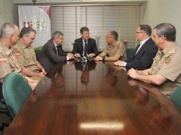 MP e PM firmam parceria para desenvolver novo aplicativo de serviços policiais policiais reunidos com membros do mp em uma grande mesa de madeira