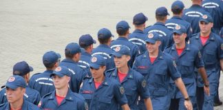 homens uniformizados marchando em duas linhas opostas, uma para cada lado, paralelamente