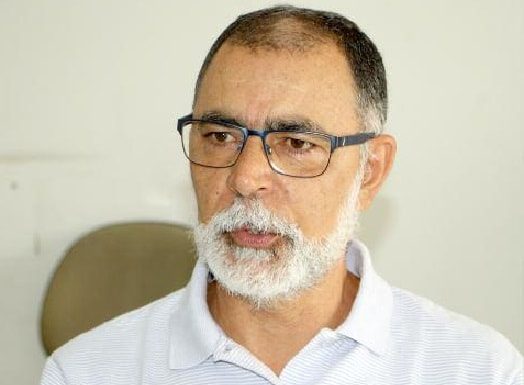 joão batista nunes falando; ele tem barba branca e usa óculos