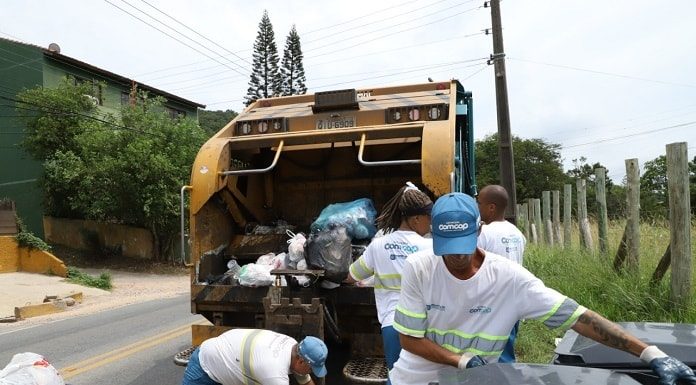 garis da comcap pegando lixo em contentores atrás de um caminhão