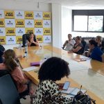 prefeita na ponta de grande mesa com mais pessoas em volta no gabinete da prefeitura de são josé