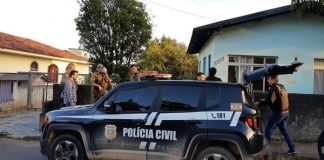 jeep renegade da polícia civil parado em frente de uma casa com polícias e outros homens em volta