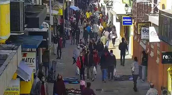 pessoas andando de mascaras e roupas de frio no calcadao da rua conselheiro mafra centro florianopolis