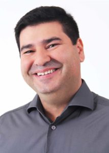 Vereador Nadir Arruda de perfil sorrindo, com camiseta cinza