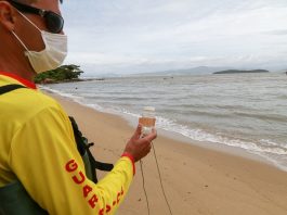 bombeiro faz coleta de água em praia para verificar índice de poluição nos pontos do litoral