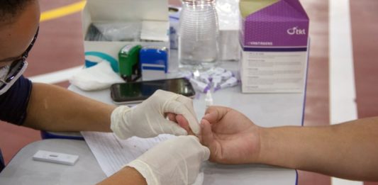 São José tem 23 mil casos confirmados - mulher faz teste de coronavírus no dedo de um homem