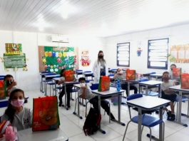 professora em sala de aula com alguns alunos em carteiras, todos de máscara - justiça anula a suspensão de aulas na grande florianópolis