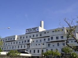 Visão lateral diagonal do Hospital Regional de São José, que registrou ontem o segundo apagão em março. A estrutura do hospital é grande, um prédio branco e em cima se lê a identificação. O céu está azul e há algumas árvores em volta.
