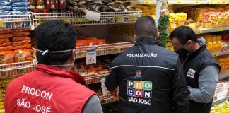 Sete supermercados de São José cobravam preços diferentes do indicado na prateleira - fiscais do procon ao lado de produtos de macarrão