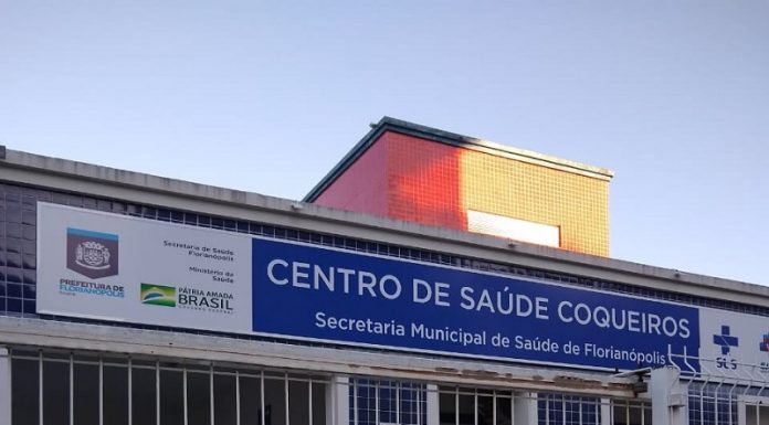 Foto da frente do centro de Saúde de Coqueiros, que tem um recado colado na grade de entrada, dizendo que por ato de violência a unidade estará fechado. Os profissionais relatam ameaças de pacientes aos funcionários do centro de saúde de coqueiros, em Florianópolis.