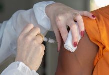 vacinação de doses de reforço contra covid na grande florianópolis - profissional de saúde vacina pessoa no braço