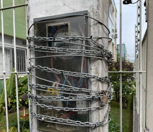 correntes em volta de relógio de luz em poste