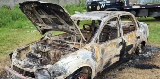 chevrolet corsa sedan destruído pelo fogo em área aberta - Carro é incendiado no bairro Forquilhinha e polícia busca por possível vítima