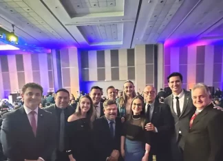 Foto mostra deputados e senadores catarinenses ao lado de representantes da Abrasel SC. Todos estão reunidos em ambiente interno, posando para a foto com sorrisos. A imagem foi feita durante o lançamento do 37º Congresso da Abrasel, em Brasília.