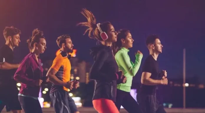 Pessoas correndo à noite em uma corrida de rua, representando a Ibagy 55 Anos Night Run em Florianópolis.