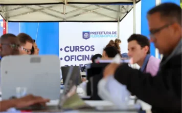 Stands da Prefeitura de Florianópolis em local de atendimento ao público, oferecendo vagas e orientações do programa Floripa Mais Empregos.