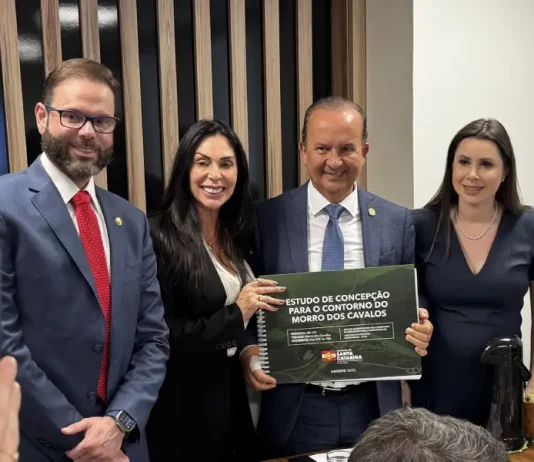 Governador de Santa Catarina, acompanhado da comitiva catarinense, segura em mãos o Estudo de Concepção para o contorno do Morro dos Cavalos, durante apresentação oficial em Brasília.