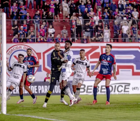 Jogadores de Figueirense e Marcílio Dias disputam bola em campo, destaque da semana do futebol catarinense