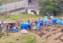 Grupo de pessoas monta barracas nos terrenos da União durante invasão no bairro Bela Vista, em São José.