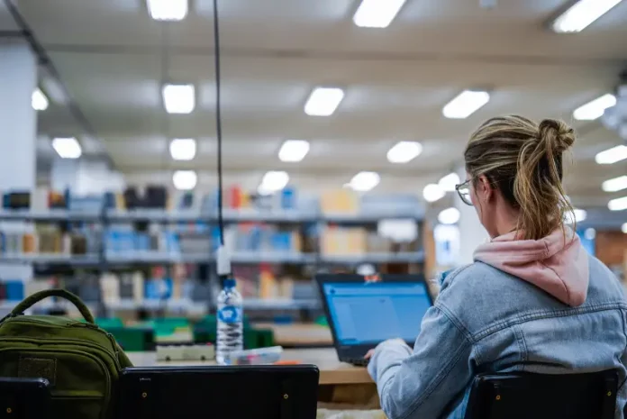Estudante do Universidade Gratuita usando notebook em sala de aula