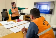 Agentes da Defesa Civil de São José analisam documentos sobre áreas de risco que receberão obras do Novo PAC.