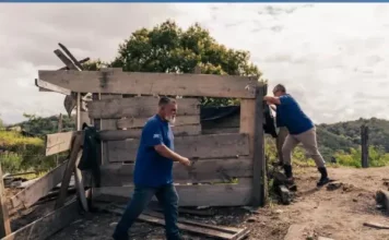 Agentes da Prefeitura de São José demolindo construções irregulares durante operação de fiscalização em área de preservação.