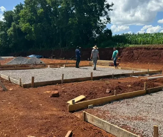 Trabalhadores atuam na preparação do terreno para a construção das moradias em Caibi, ilustrando o avanço do programa Casa Catarina
