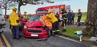 Bombeiros trabalhando na remoção de vítimas presas às ferragens após acidente de trânsito entre carro e ônibus na Costeira, em Florianópolis.