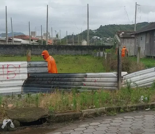 Funcionários da Prefeitura de São José desmontam cerca em terreno público para impedir ocupação irregular e proteger a área municipal.