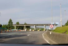 Imagem mostra uma praça de pedágio da Autopista Planalto Sul na BR-116, com cabines de cobrança, sinalização viária e pistas de acesso, ilustrando o local onde os motoristas realizam o pagamento da tarifa.