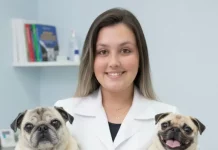 A importância do conhecimento técnico em estudos sobre prevenção e saúde integrativa em animais de companhia Vanessa Maria Dias segurando dois cães, destacando cuidado e bem-estar de animais de companhia.