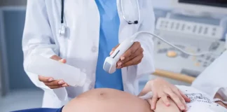 Foto mostra uma gestante em exame de ultrassom, ilustrando cuidados do pré-natal e a humanização da assistência obstétrica.