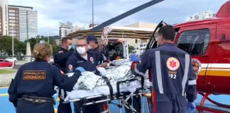 Equipe do serviço aeromédico do Samu realiza atendimento de emergência e prepara paciente para transporte aéreo, ilustrando o uso do Programa Sangue Total no atendimento pré-hospitalar em Santa Catarina.