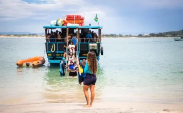 Florianópolis abre credenciamento para transporte à Ilha do Campeche para a temporada 2025/2026 Embarcação de transporte turístico desembarca passageiros na Ilha do Campeche, ilustrando o acesso de visitantes à unidade de conservação.