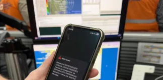 Celular exibe alerta de emergência da Defesa Civil durante simulado de desastres em Santa Catarina, demonstrando o funcionamento do sistema de avisos à população.