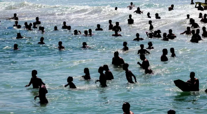 Último fim de semana de verão com sol e calor em SC Turistas se refrescando na água durante sol e calor no litoral catarinense