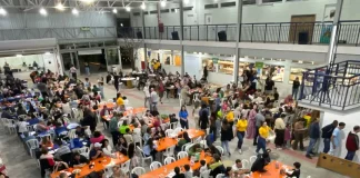 Público participa da festa do Educandário Santa Catarina em São José, com mesas cheias, bingo e atividades comunitárias em espaço coberto da instituição.