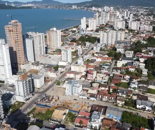 Vista aérea de Balneário Piçarras mostra área urbana com prédios e a orla, ilustrando o crescimento da cidade e o contexto de desenvolvimento abordado pelo programa SC Cidades do Futuro.