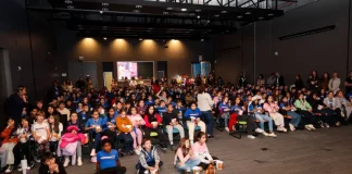 Crianças assistindo cinema pelo projeto Sapiens Parque