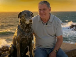 Foto do Deputado Mario Motta eo lado da estátua do cão Orelha