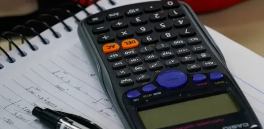 Últimos dias para aderir ao Recupera Mais com descontos no ICMS e ITCMD Mesa com calculadora, caderno e caneta, representando planejamento financeiro e organização de dívidas no contexto do programa Recupera Mais.