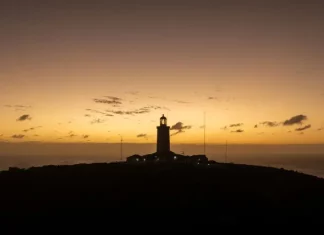 Junho começa com clima típico de outono em Santa Catarina Foto de um farol no por de sol, mostrando temperatura tipica de outono no início de junho