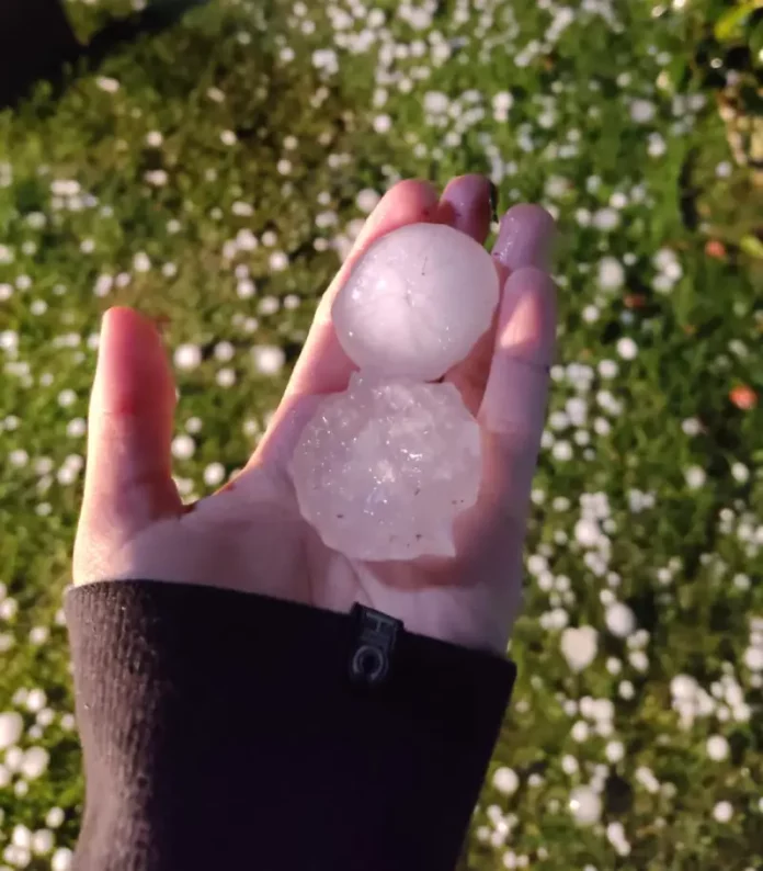 Pessoa segurando granizo na mão após temporal em Florianópolis