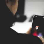 Prefeitura de São José alerta para golpes com falsos boletos e mensagens sobre alvarás Pessoa mechendo no celular indicando o golpe de falsos boletos na prefeitura de São José