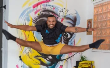 Artista salta em frente a mural colorido, em imagem que ilustra os novos editais da Política Nacional Aldir Blanc em São José.