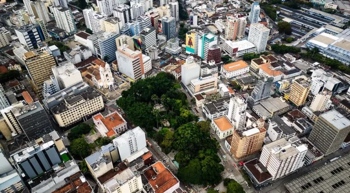 Vista aérea do Centro de Florianópolis, com prédios, ruas e áreas arborizadas, ilustrando os desafios do trânsito e transporte na Capital e a discussão sobre mobilidade urbana.